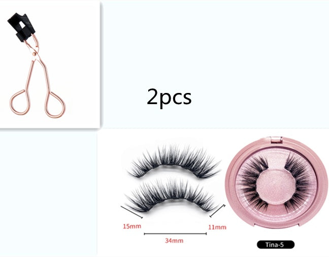 Set of false eyelashes with a pair, a case, and a pair of eyelash clippers on a white background.